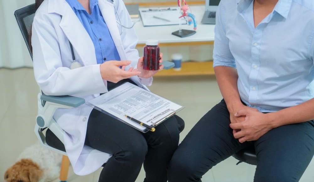 Young Asian man consults his doctor about the concept of enlarged prostate gland.