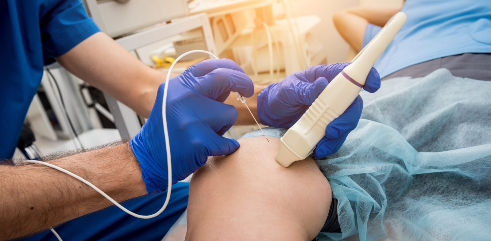 interventional radiologist using imaging to place a catheter in patient